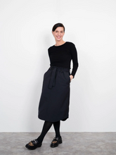Load image into Gallery viewer, The Assembly Line Sewing Pattern. Model Wearing A-Line Midi Skirt