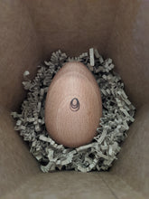 Load image into Gallery viewer, Socko mending egg in nest of recycled packaging paper shreds. Socko mending egg. Wooden Darning egg. White background. Sustainable Haberdashery. Sewing tools. Swiss darning. Mending. Glasgow