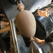 Load image into Gallery viewer, Socko mending egg. Wooden Darning egg. White background. Sustainable Haberdashery. Sewing tools. Swiss darning. Mending. Wood turning product in progress. Mending egg on lathe. Woodworking sewing tools.
