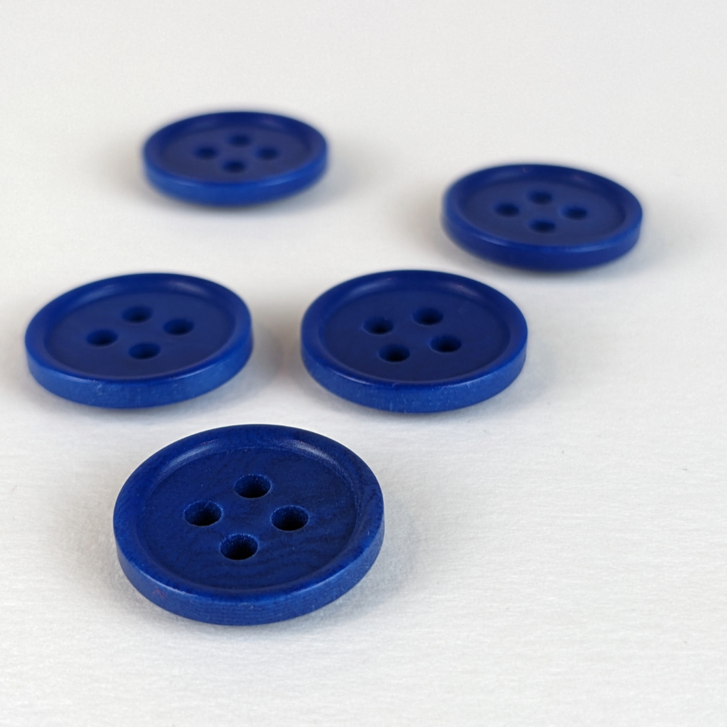 15mm four hole blue corozo buttons on white background