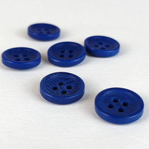 12mm four hole blue corozo buttons on white background