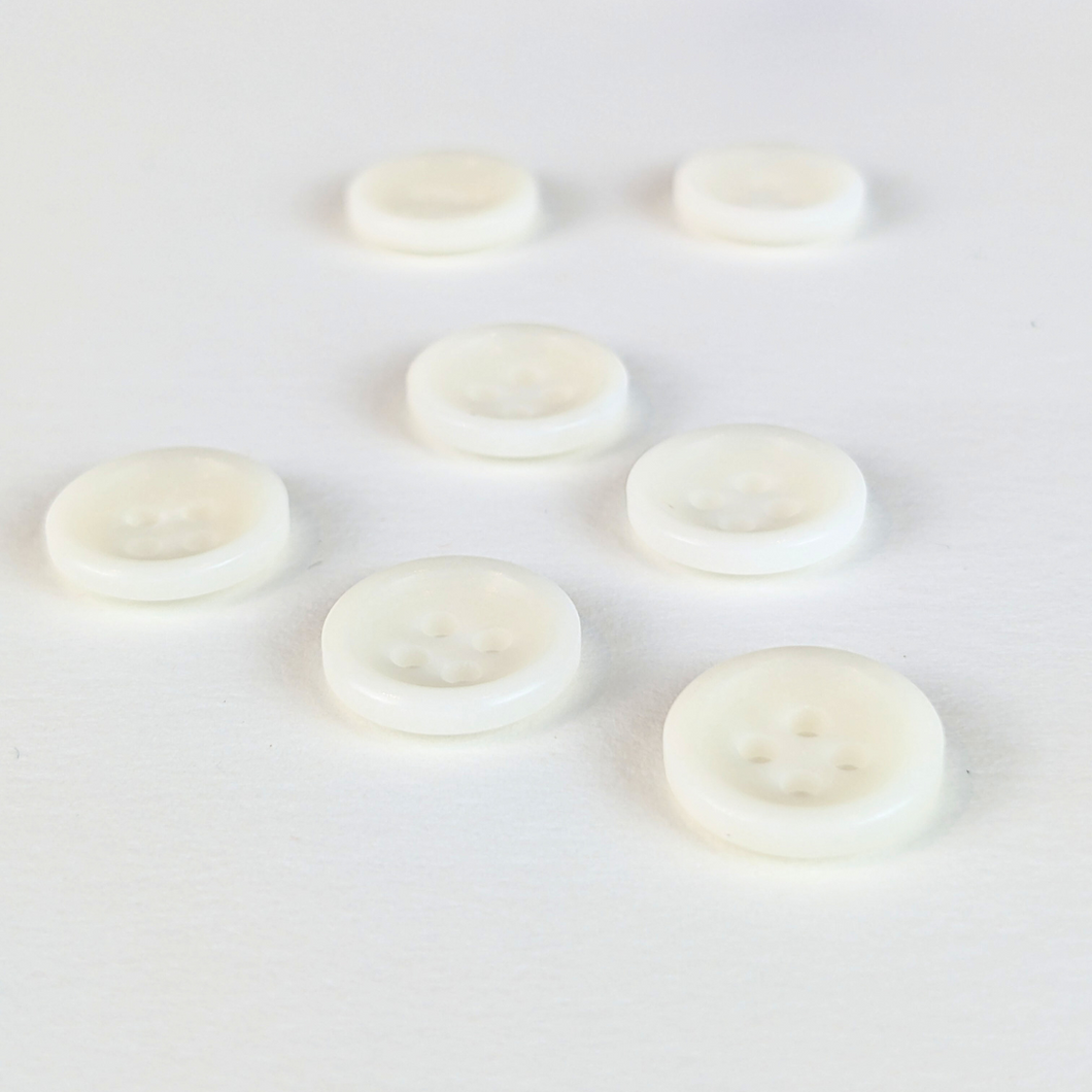 12mm four hole natural cream buttons on white background