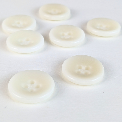 15mm four hole natural cream buttons on white background
