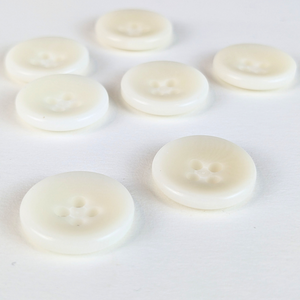15mm four hole natural cream buttons on white background