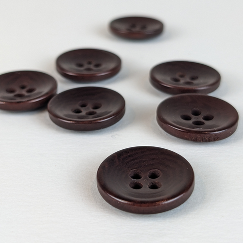 15mm four hole brown corozo buttons on white background