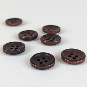 12mm four hole brown corozo buttons on white background