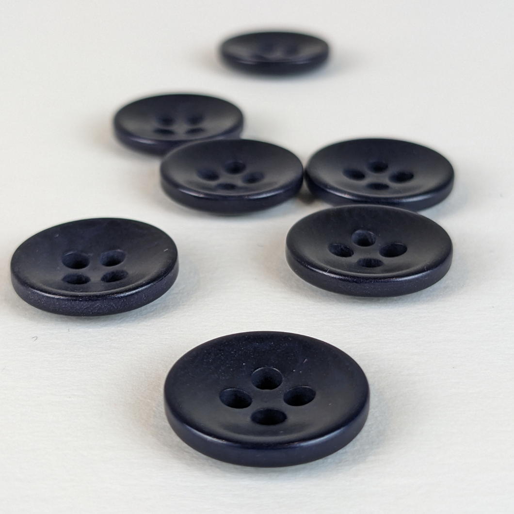 15mm four hole navy corozo buttons on white background