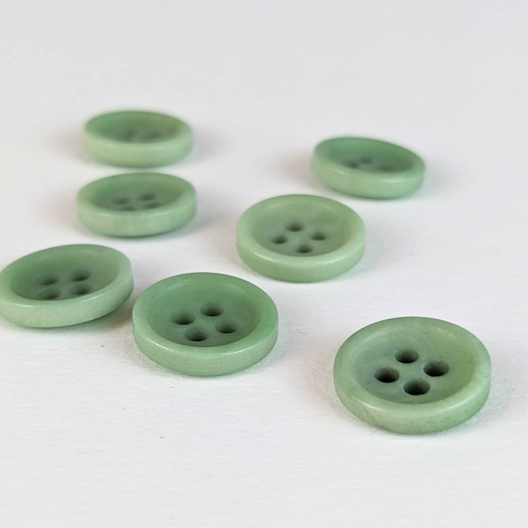 12mm four hole mint corozo buttons on white background