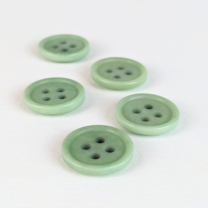 15mm four hole mint corozo buttons on white background