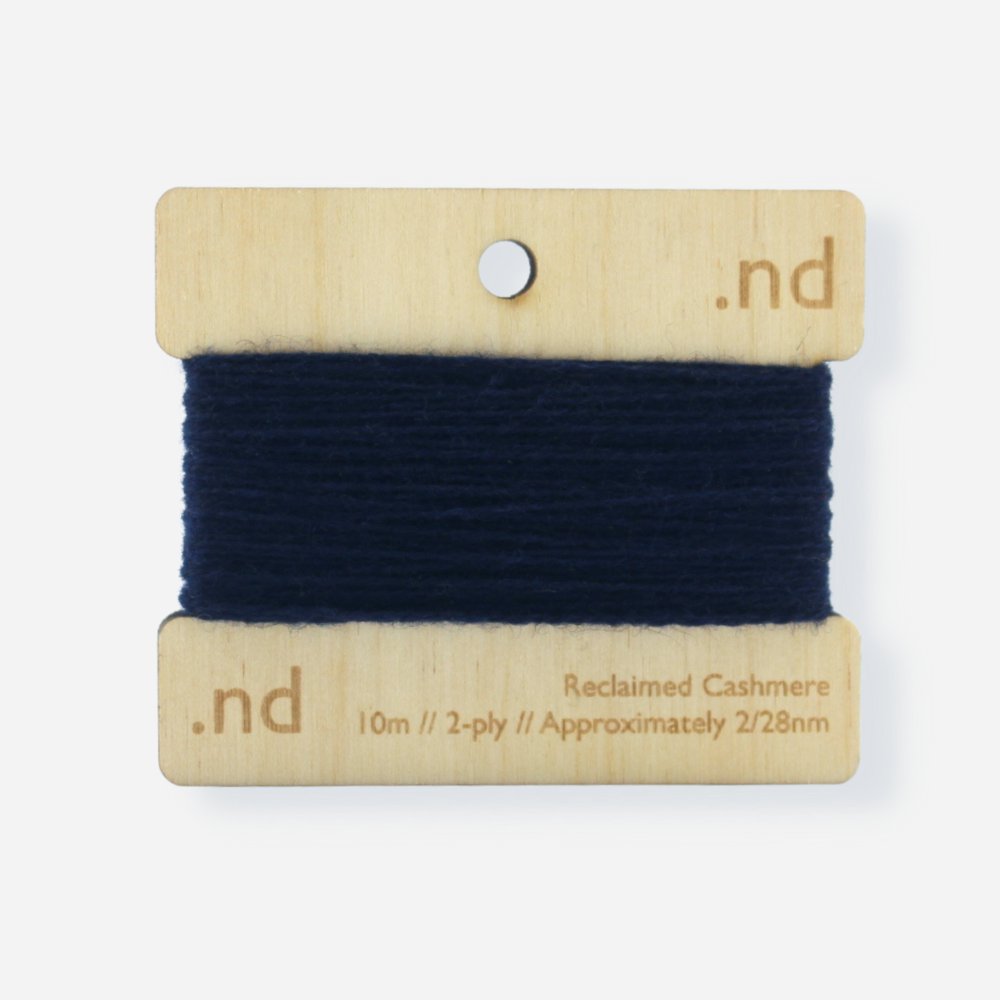 Navy Blue reclaimed / recycled 100% cashmere mending yarn. 10m wound horizontally onto bespoke laser cut and branded ply. Approximately 2/28nm. perfect weight for visible and invisible mending, darning and Swiss darning knitwear repairs. Made by Second Cashmere at Bawn Glasgow