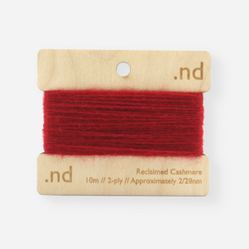 Deep red reclaimed / recycled 100% cashmere mending yarn. 10m wound horizontally onto bespoke laser cut and branded ply. Approximately 2/28nm. perfect weight for visible and invisible mending, darning and Swiss darning knitwear repairs. Made by Second Cashmere at Bawn Glasgow