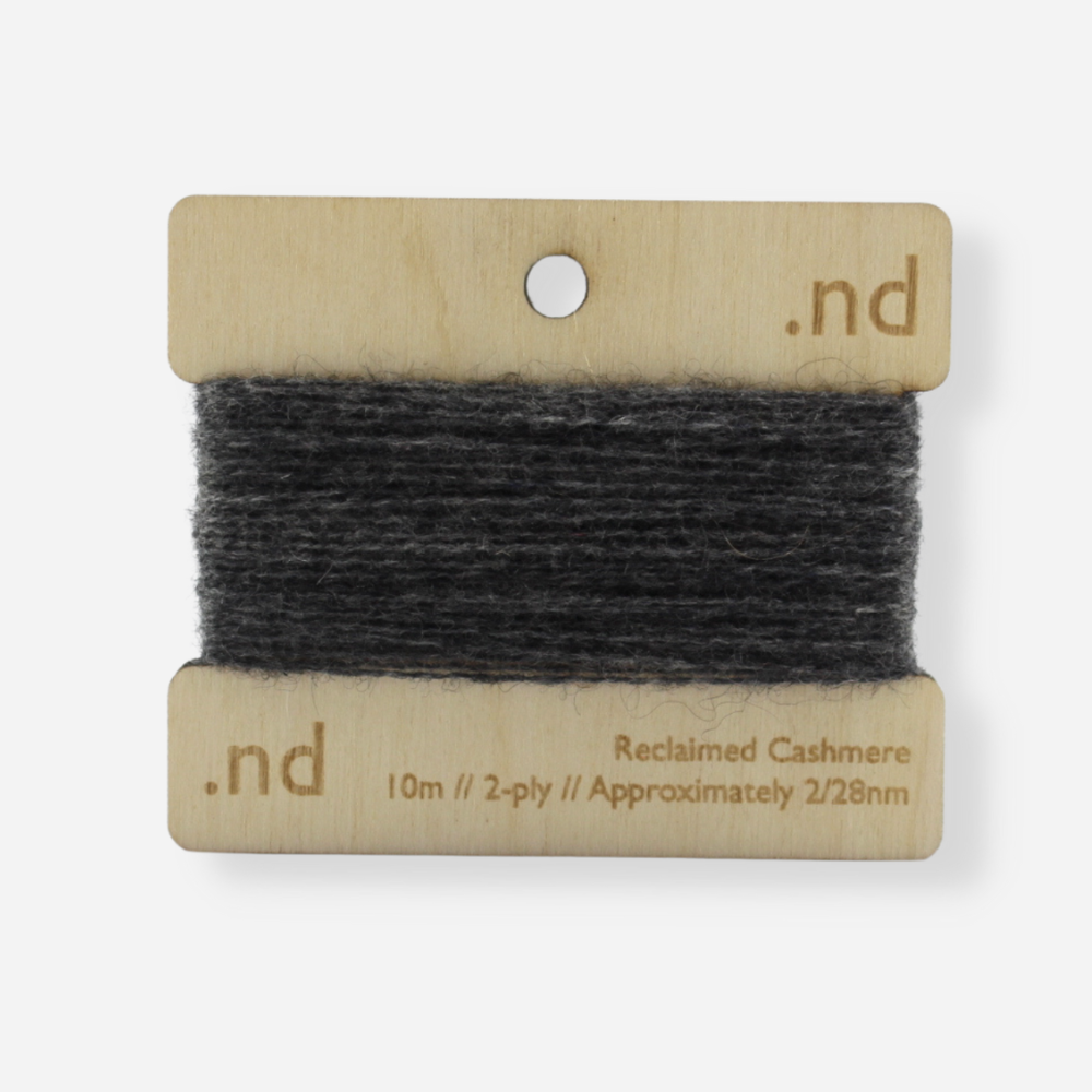 Grey reclaimed / recycled 100% cashmere mending yarn. 10m wound horizontally onto bespoke laser cut and branded ply. Approximately 2/28nm. perfect weight for visible and invisible mending, darning and Swiss darning knitwear repairs. Made by Second Cashmere at Bawn Glasgow