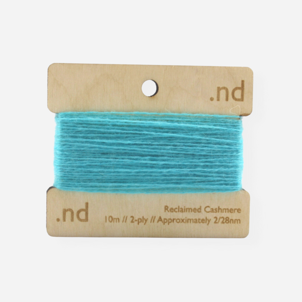 Aqua reclaimed / recycled 100% cashmere mending yarn. 10m wound horizontally onto bespoke laser cut and branded ply. Approximately 2/28nm. perfect weight for visible and invisible mending, darning and Swiss darning knitwear repairs. Made by Second Cashmere at Bawn Glasgow