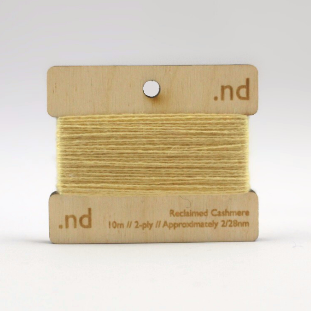 Yellow Gold reclaimed / recycled 100% cashmere mending yarn. 10m wound horizontally onto bespoke laser cut and branded ply. Approximately 2/28nm. perfect weight for visible and invisible mending, darning and Swiss darning knitwear repairs. Made by Second Cashmere at Bawn Glasgow