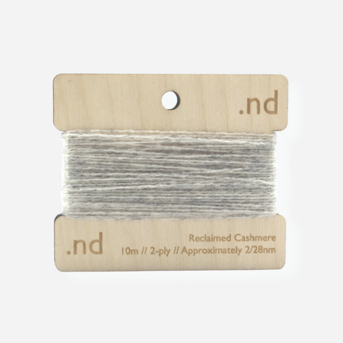 Ligth grey reclaimed / recycled 100% cashmere mending yarn. 10m wound horizontally onto bespoke laser cut and branded ply. Approximately 2/28nm. perfect weight for visible and invisible mending, darning and Swiss darning knitwear repairs. Made by Second Cashmere at Bawn Glasgow