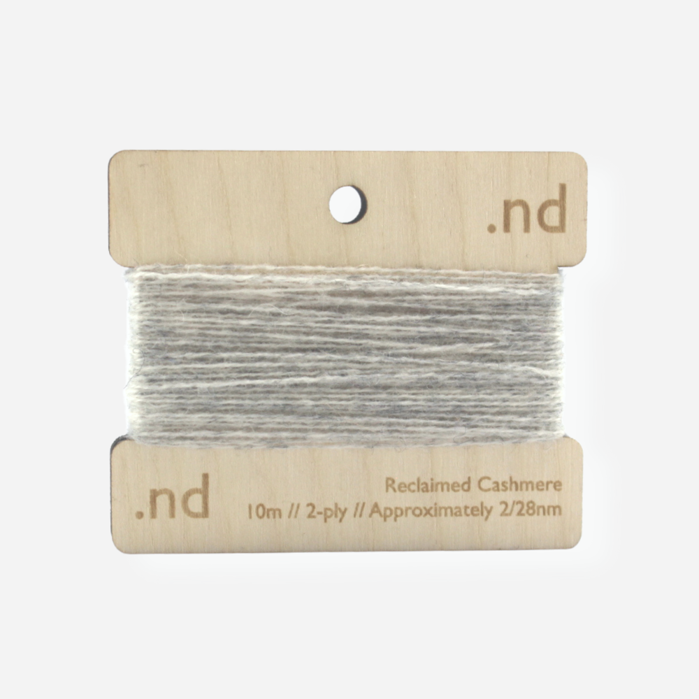 Ligth grey reclaimed / recycled 100% cashmere mending yarn. 10m wound horizontally onto bespoke laser cut and branded ply. Approximately 2/28nm. perfect weight for visible and invisible mending, darning and Swiss darning knitwear repairs. Made by Second Cashmere at Bawn Glasgow
