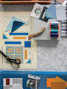 Flat lay of sketches, samples and sewing tools for quilting
