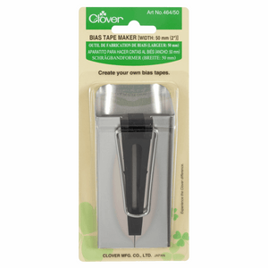 Metal and black plastic gadget for making 50mm bias binding tape by Clover. In branded green packaging