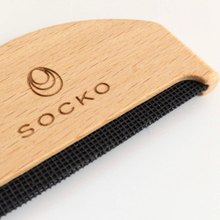 Load image into Gallery viewer, Close up of Socko Pilling comb for debobbling your knitwear. care for cashmere. clothing care. wooden handle clothing comb. white background flat lay.
