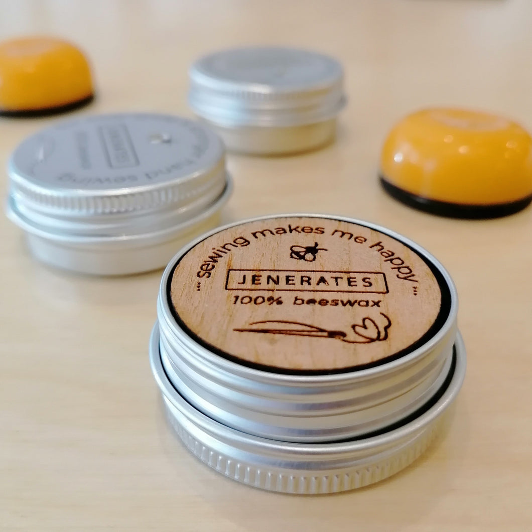 Small metal tin of beeswax on laser cut wooden disk 