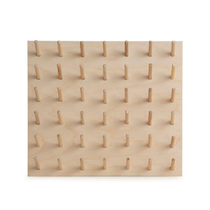 Small birch ply peg board for thread storage. Made by Laura ter Kuile for Bawn Textiles. 