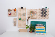 Load image into Gallery viewer, Large design birch ply peg boards on display in creative studio. All in one model incluses more than one size and spacing of pegs. 
