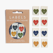 Load image into Gallery viewer, Flat Lay Kylie and the Machine Labels on white background - multiple colourful labels in paper sleeve saying:  I Love Linen
