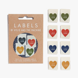 Flat Lay Kylie and the Machine Labels on white background - multiple colourful labels in paper sleeve saying:  I Love Linen